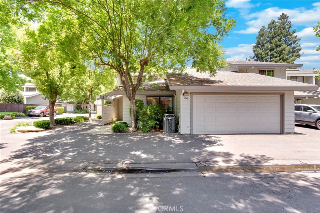 3350 M Street, Unit 24 Merced, CA 95348 - Photo 37 of 38 a front view of a house with a yard and garage