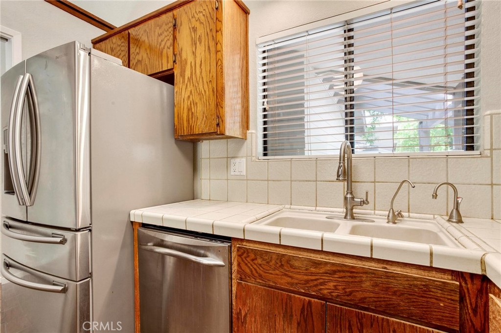 3350 M Street, Unit 24 Merced, CA 95348 - Photo 8 of 38 a kitchen with a sink and a refrigerator