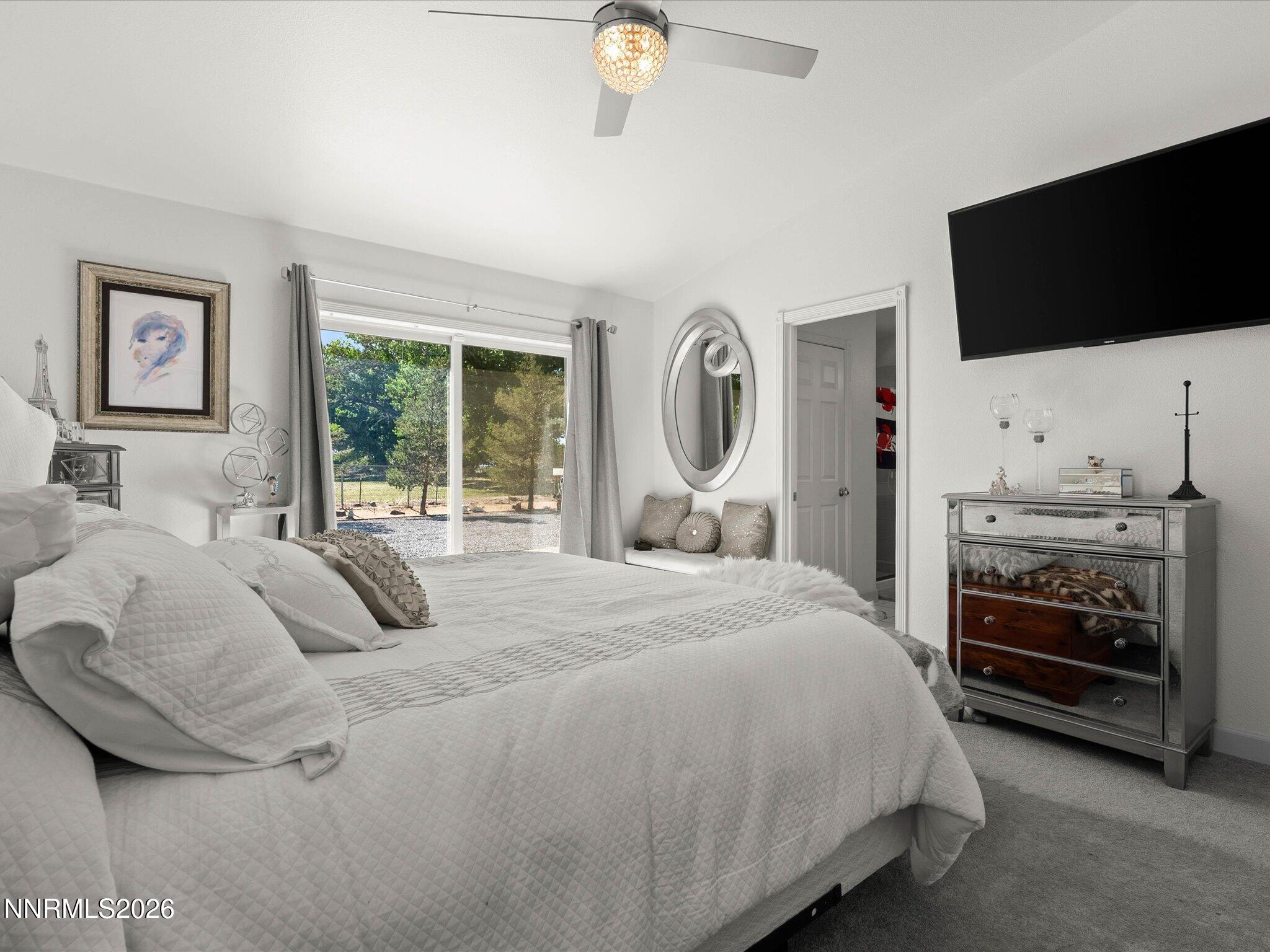 1080 Red Rock Road Fernley, NV 89408 - Photo 21 of 45 a bedroom with a bed and a flat tv screen on the dresser