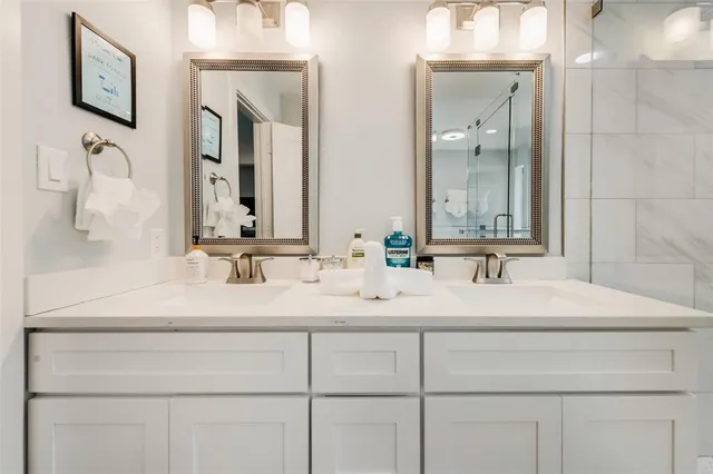 a spacious bathroom with a tub sink shower and mirror