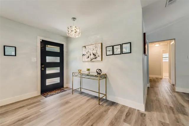 a workspace with wooden floor and windows