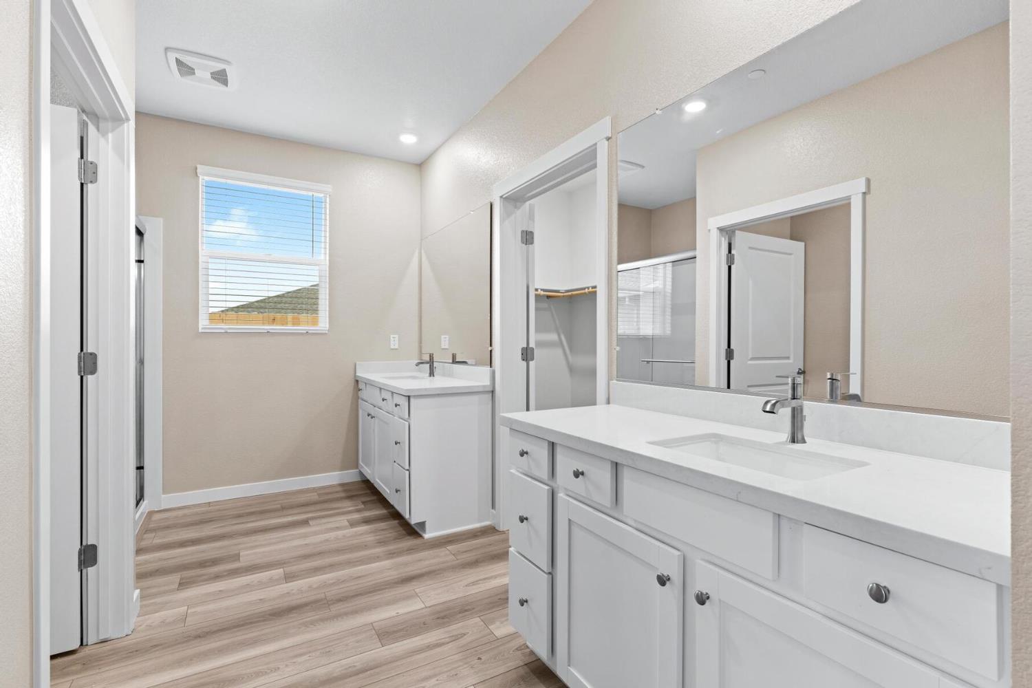 3440 Jake Way Denair, CA 95316 - Photo 11 of 18 a spacious bathroom with a double vanity sink a mirror and a