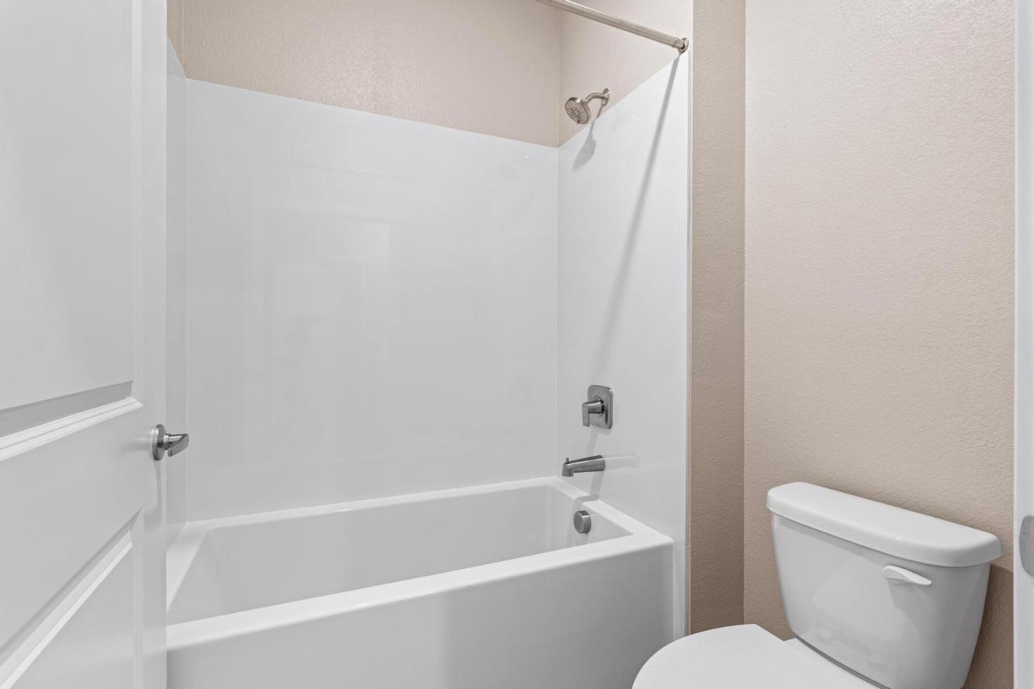 3440 Jake Way Denair, CA 95316 - Photo 17 of 18 a white bath tub sitting next to a white toilet and sink
