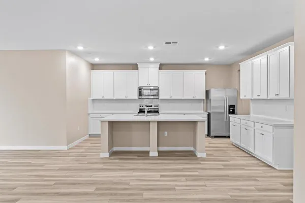 a kitchen with a sink cabinets and window