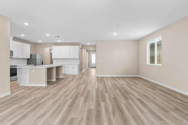 a view of kitchen with wooden floor and electronic appliances