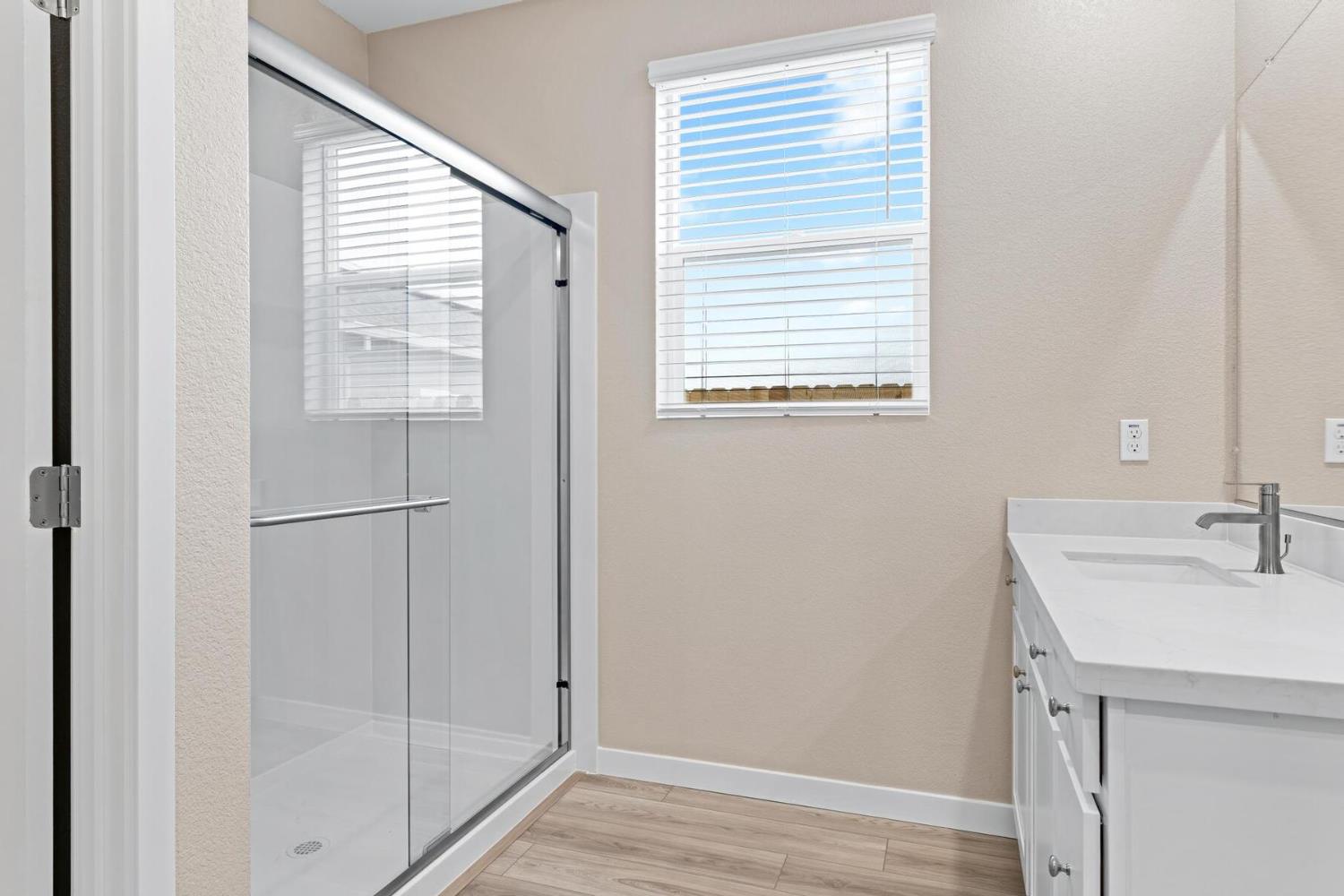 3440 Jake Way Denair, CA 95316 - Photo 10 of 18 a bathroom with a sink a mirror and next to a window
