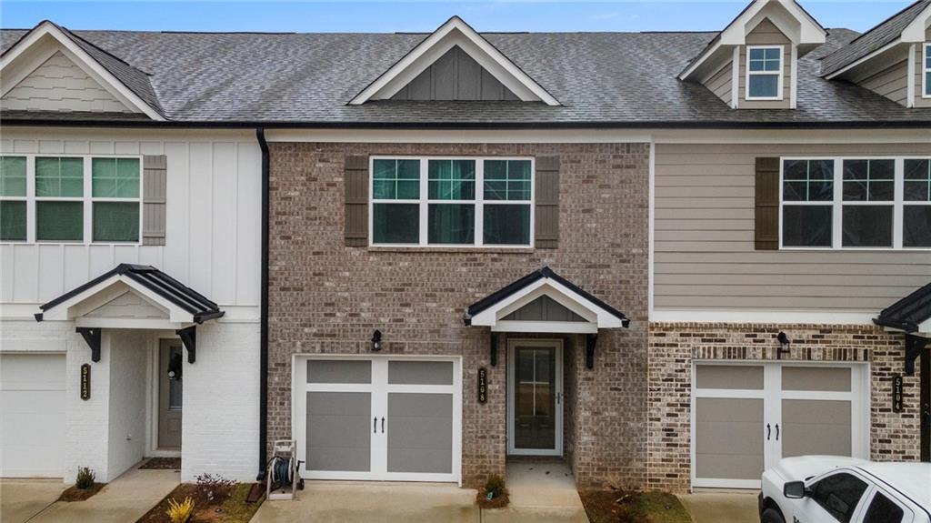 5108 Fox Den Road Oakwood, GA 30566 - Photo 1 of 1 a front view of a house with a blue gate