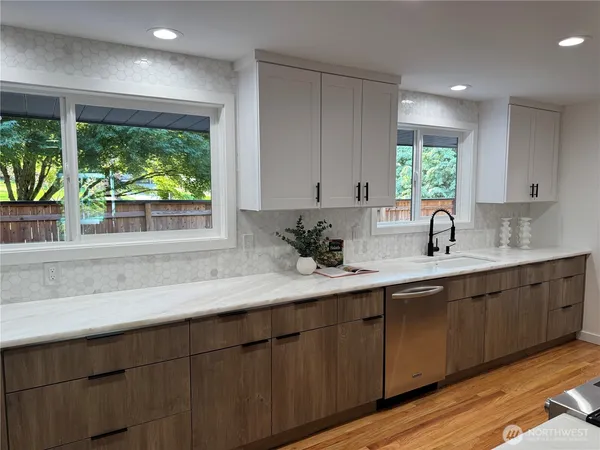 a kitchen with a sink and large window