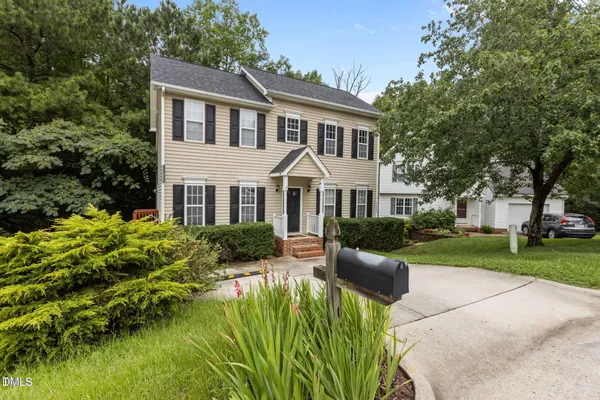 a front view of house with yard and green space