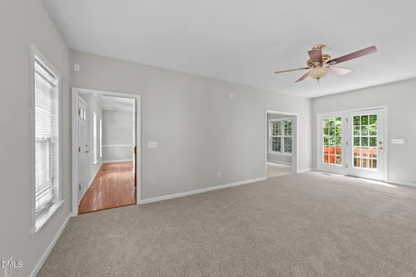 a view of a room with a ceiling fan and a window