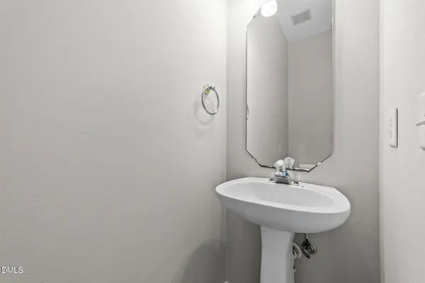 a bathroom with a sink and mirror