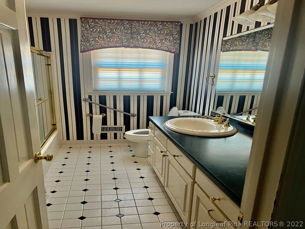 110 Bee Gee Road Lumberton, NC 28358 - Photo 15 of 42 a bathroom with a sink a mirror and a shower