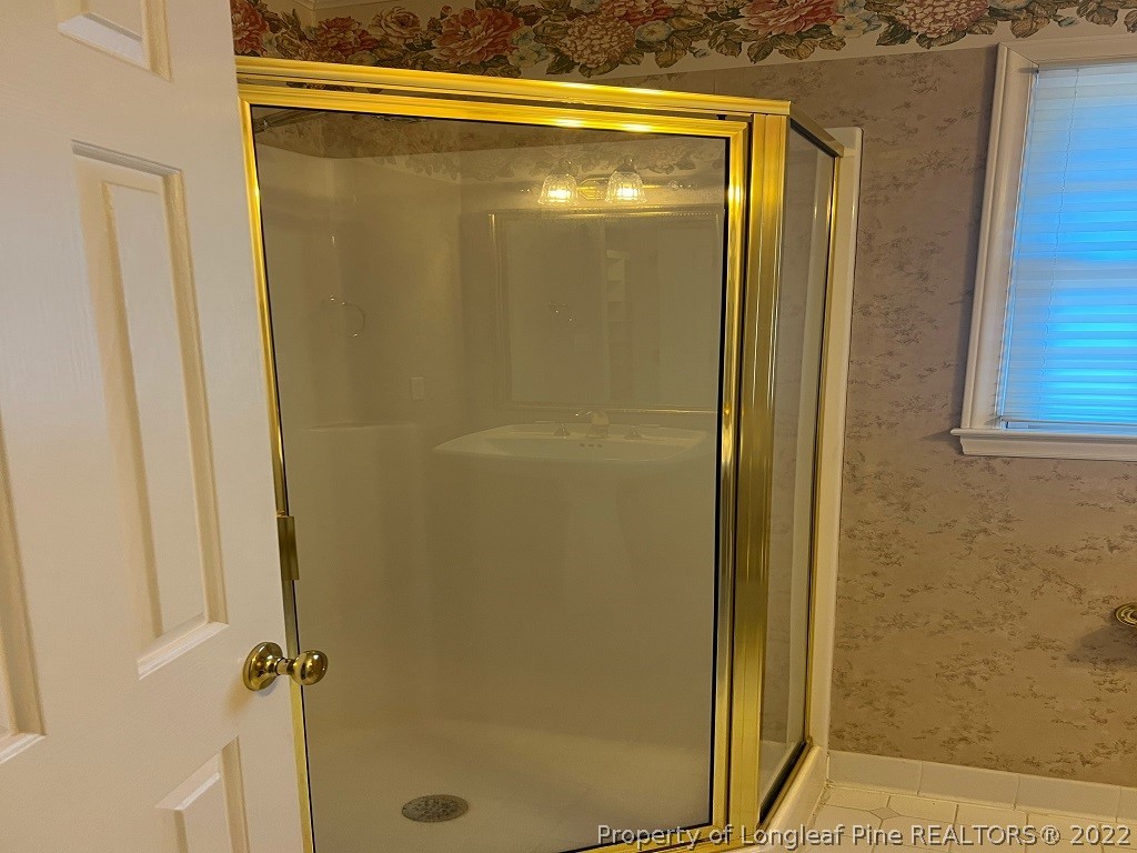 110 Bee Gee Road Lumberton, NC 28358 - Photo 18 of 42 a bathroom with a glass shower door