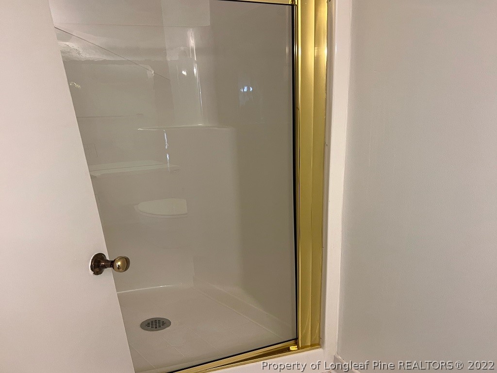 110 Bee Gee Road Lumberton, NC 28358 - Photo 19 of 42 a bathroom with a glass shower door