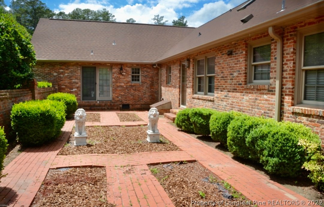 110 Bee Gee Road Lumberton, NC 28358 - Photo 2 of 42 a front view of a house with a yard and potted plants