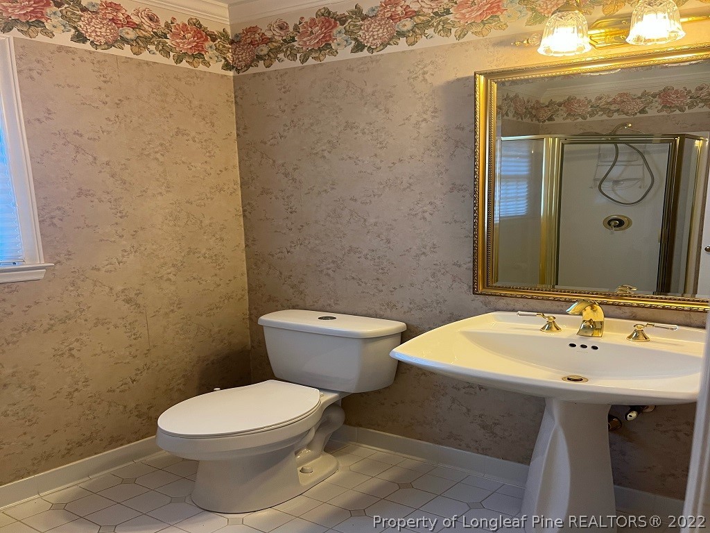 110 Bee Gee Road Lumberton, NC 28358 - Photo 25 of 42 a bathroom with a sink a toilet and mirror