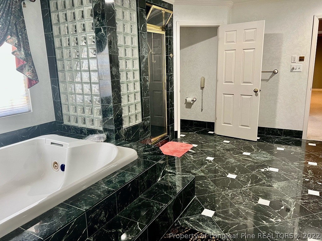 110 Bee Gee Road Lumberton, NC 28358 - Photo 28 of 42 a bathroom with a bathtub and shower