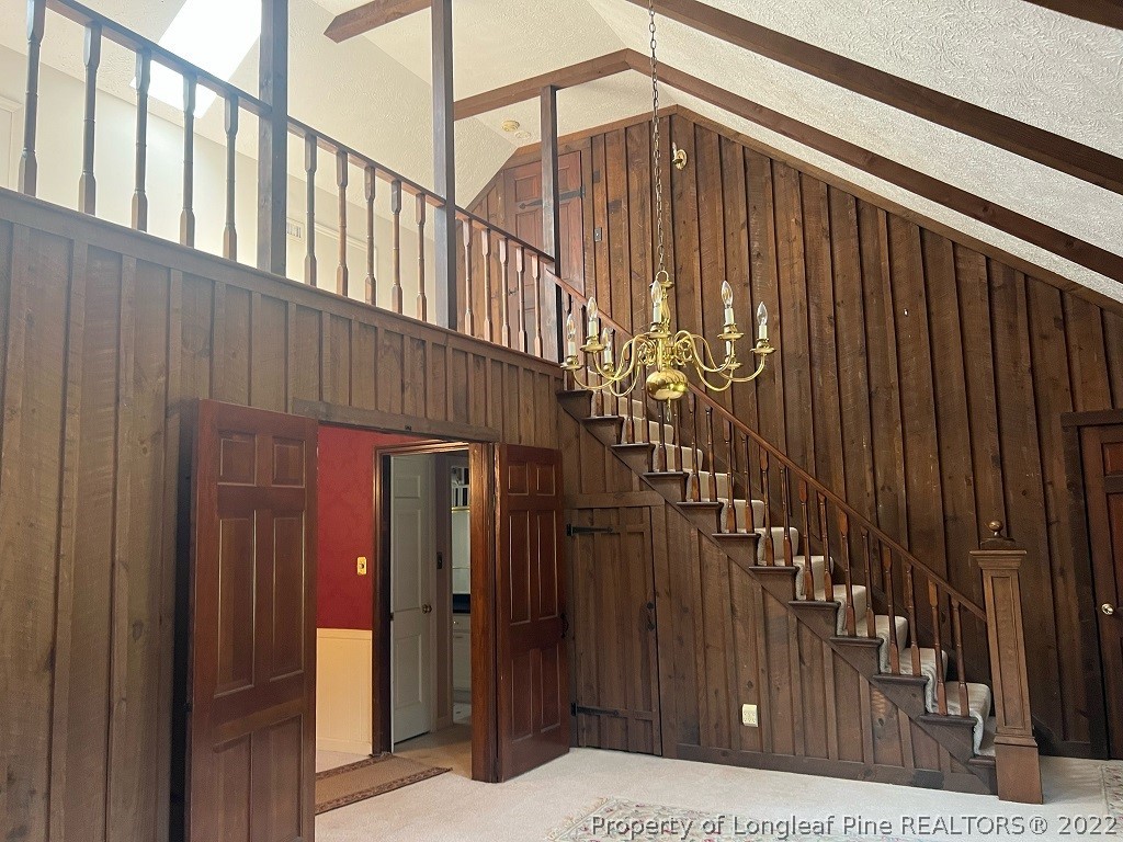 110 Bee Gee Road Lumberton, NC 28358 - Photo 40 of 42 a view of staircase with railing and a chandelier