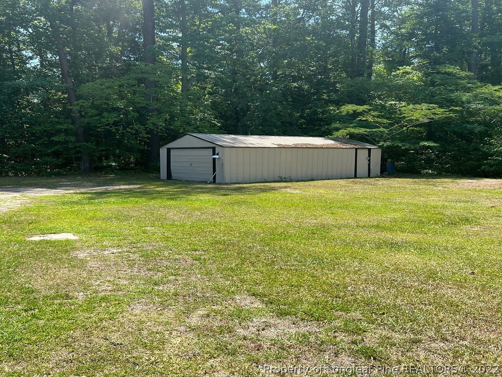 110 Bee Gee Road Lumberton, NC 28358 - Photo 9 of 42 a view of a large pool with an outdoor space and seating area