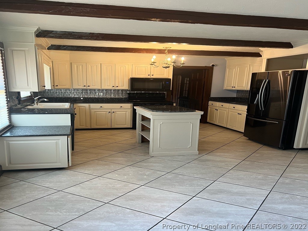 110 Bee Gee Road Lumberton, NC 28358 - Photo 10 of 42 a kitchen with stainless steel appliances kitchen island granite countertop a sink and cabinets