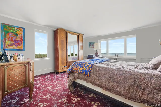 a bedroom with a bed and a dresser next to a window