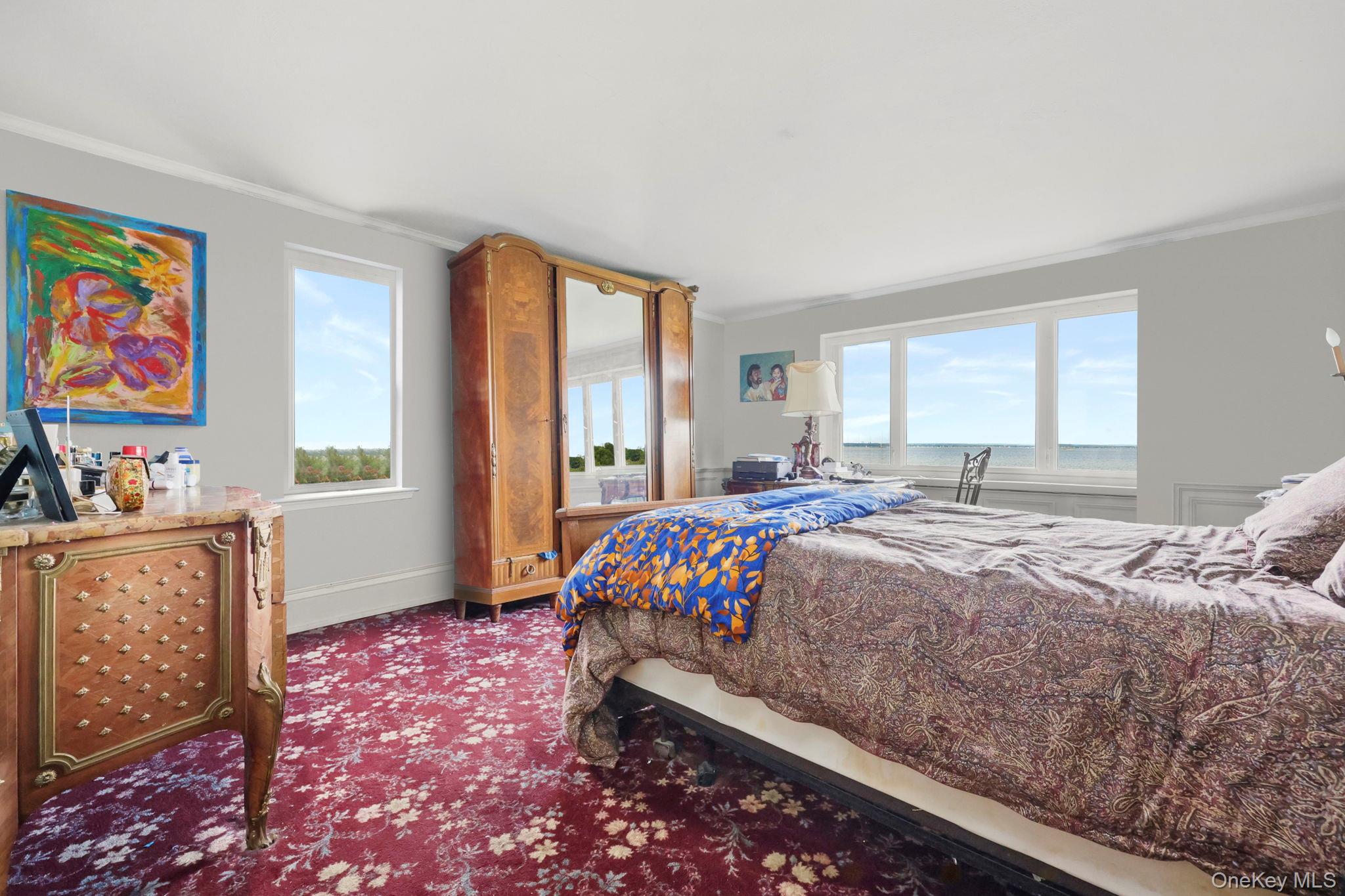 69 Cornwells Beach Road Sands Point, NY 11050 - Photo 11 of 42 a bedroom with a bed and a dresser next to a window
