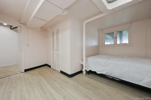 a view of a room with wooden floor and window