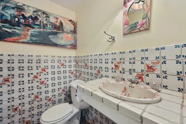 a bathroom with a sink toilet and mirror