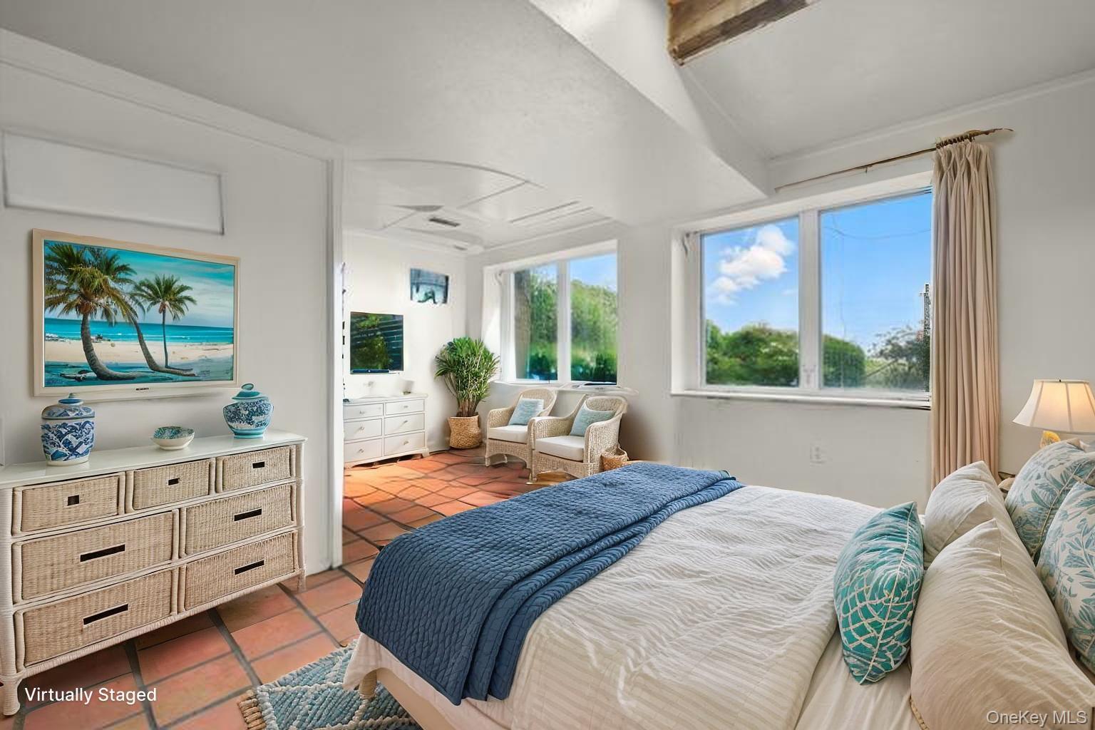 69 Cornwells Beach Road Sands Point, NY 11050 - Photo 22 of 42 a bedroom with a bed and large windows