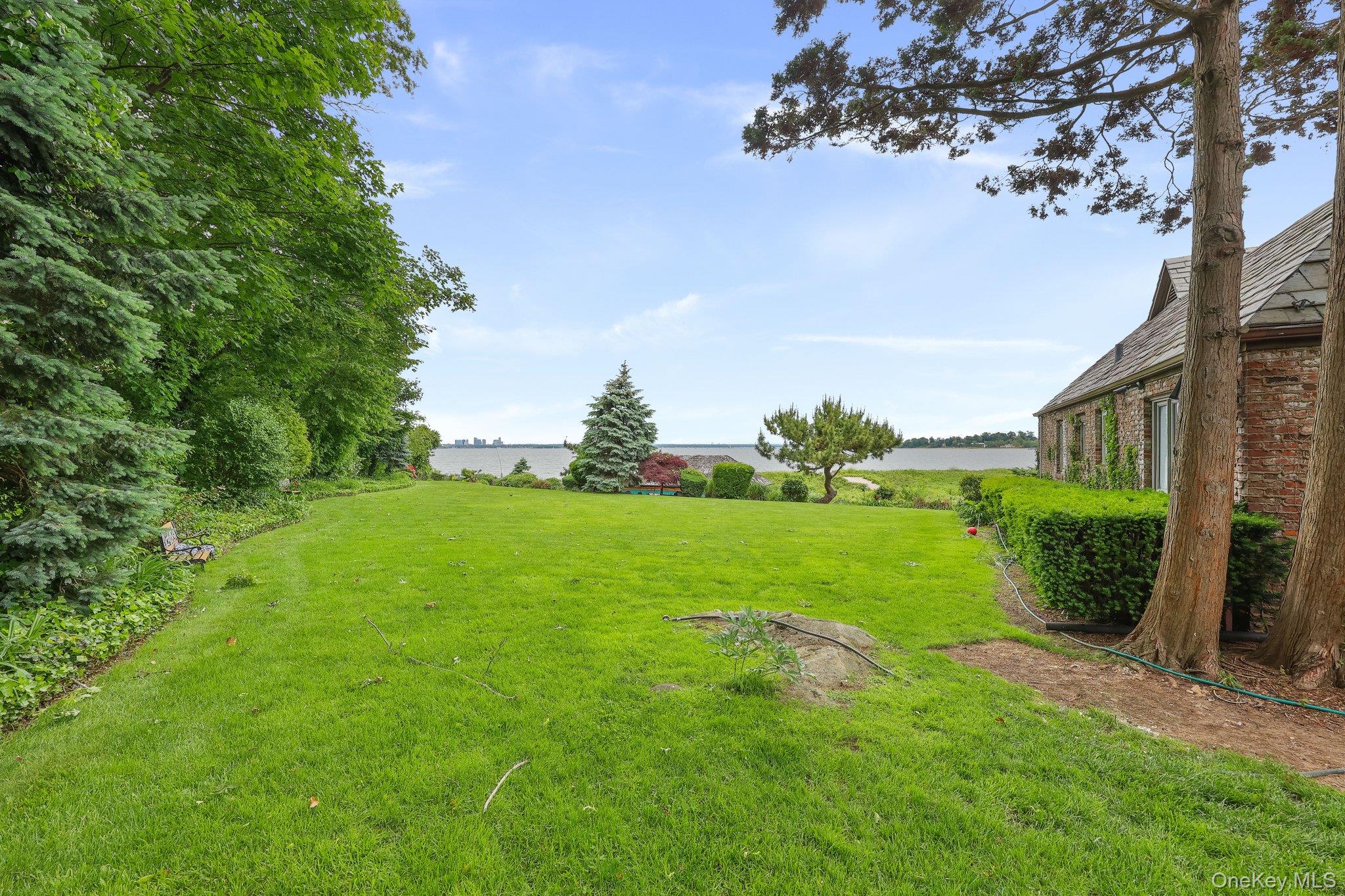 69 Cornwells Beach Road Sands Point, NY 11050 - Photo 29 of 42 a view of a garden with a building in the background