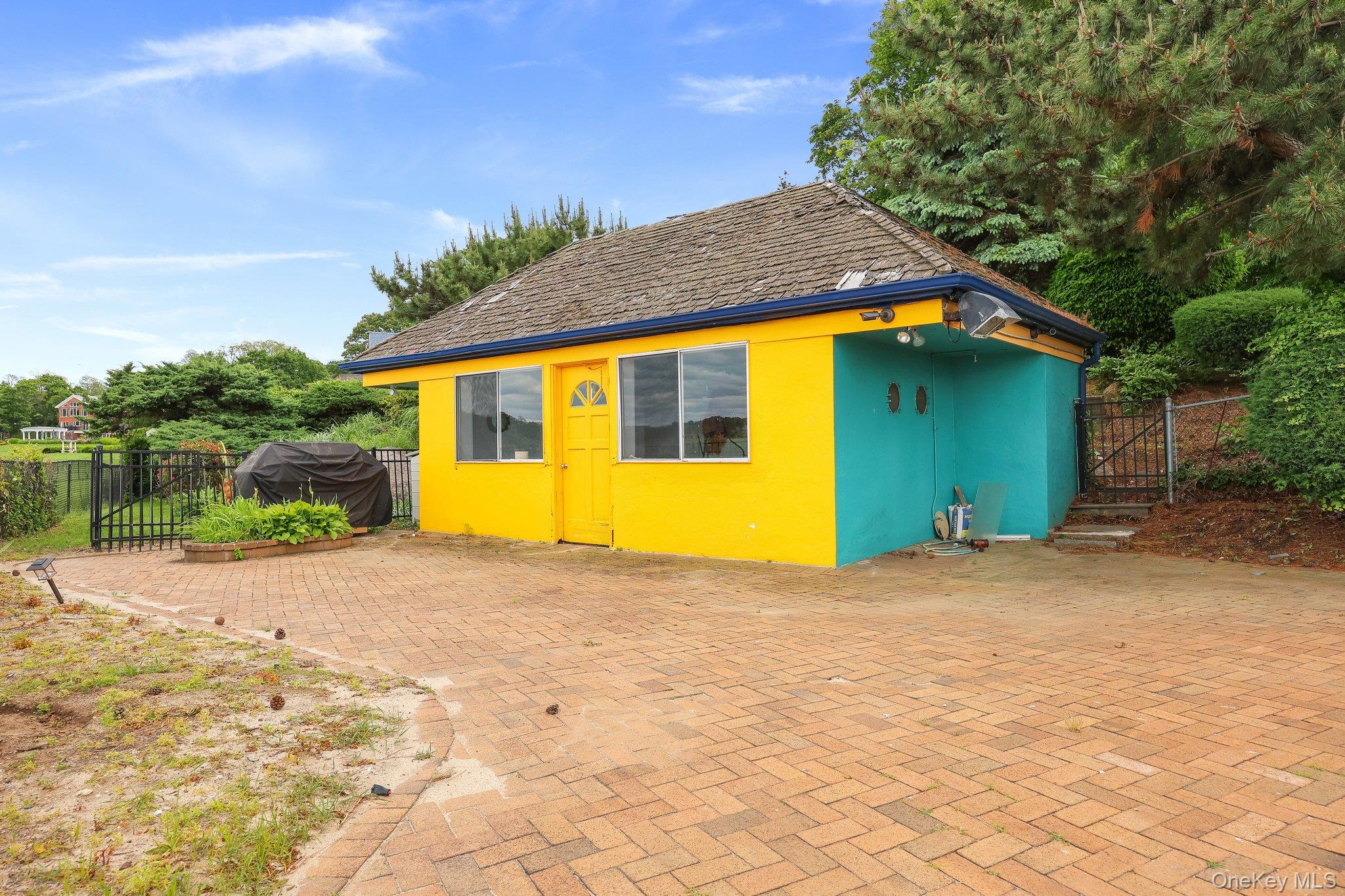 69 Cornwells Beach Road Sands Point, NY 11050 - Photo 36 of 42 a view of a house with a backyard