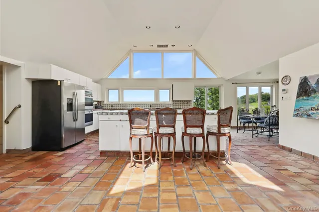 a large kitchen with a table and chairs