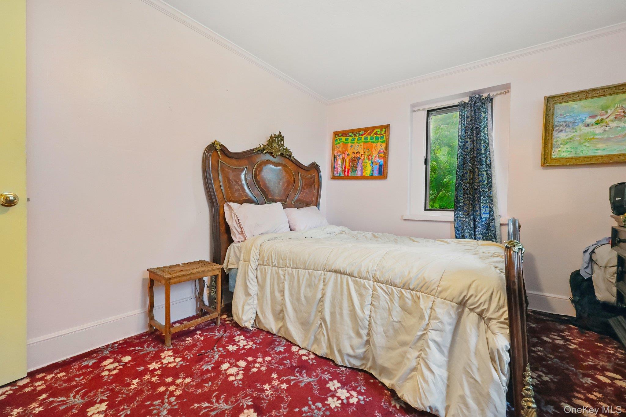 69 Cornwells Beach Road Sands Point, NY 11050 - Photo 9 of 42 a bedroom with a bed and painting on the wall