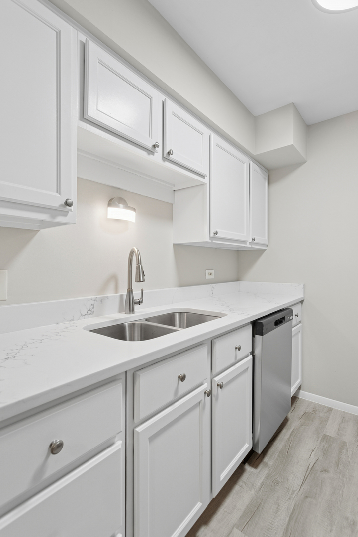 6185 Pinewood Court, Unit 202 Willowbrook, IL 60527 - Photo 16 of 20 a kitchen with white cabinets and sink