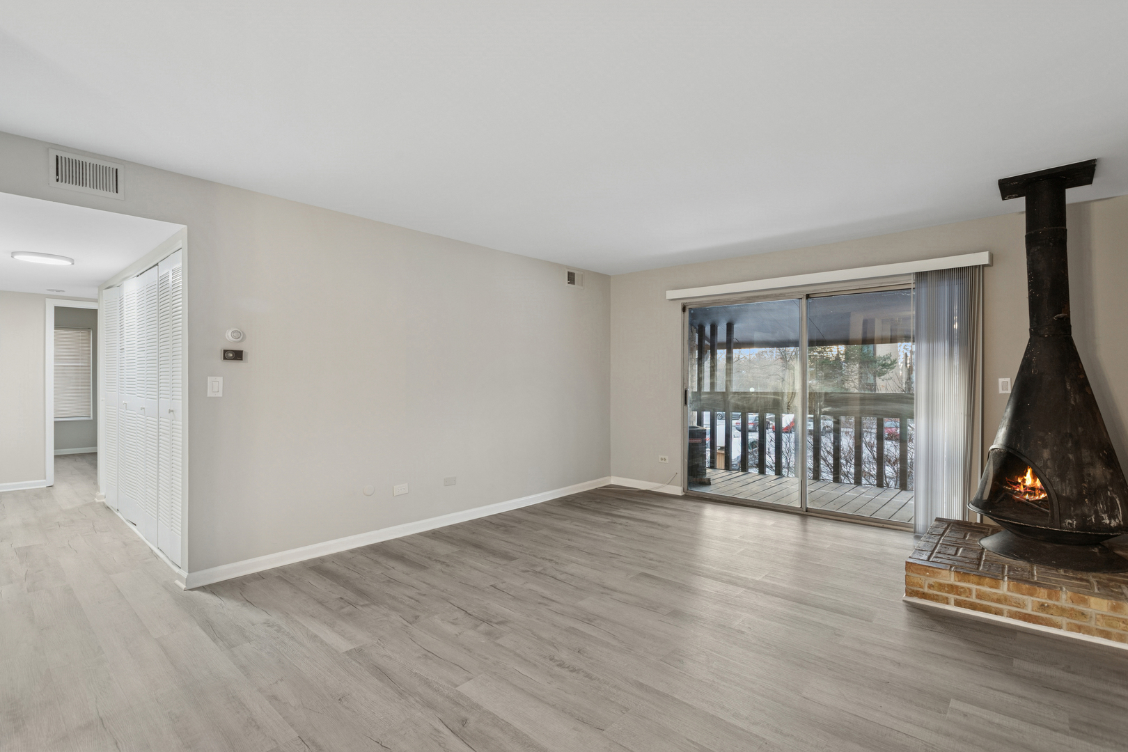 6185 Pinewood Court, Unit 202 Willowbrook, IL 60527 - Photo 4 of 20 a view of an empty room with wooden floor and a window