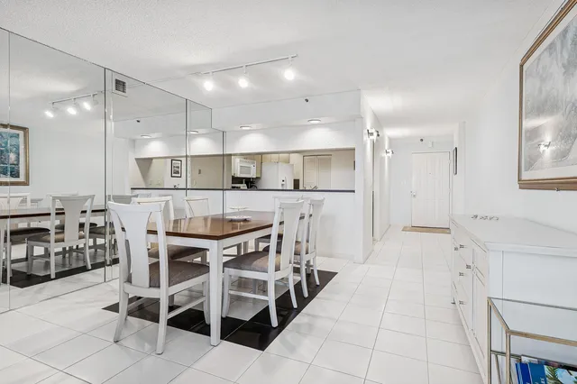 a large kitchen with a table and chairs in it