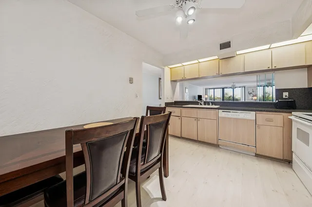 a kitchen with cabinets a sink and appliances