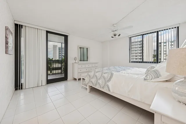 a spacious bedroom with a bed and a window