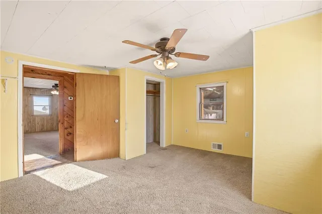a view of an empty room with a fan
