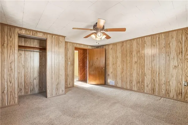 a view of a room with a window and a ceiling fan