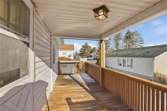 a view of a balcony with wooden floor