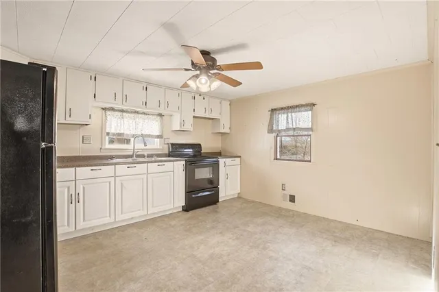 a kitchen with a white cabinets and refrigerator