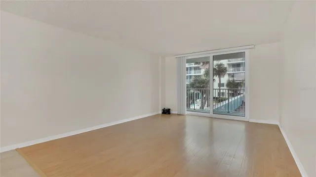 a view of a livingroom with wooden floor and a ceiling fan