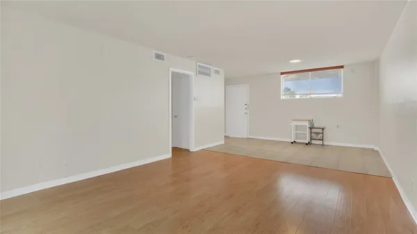 a kitchen with a refrigerator sink and cabinets