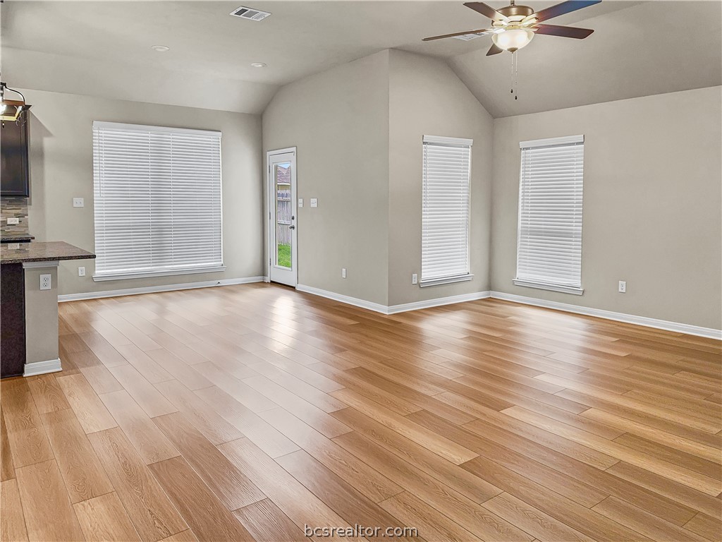 1971 Chief Street Bryan, TX 77807 - Photo 7 of 14 an empty room with wooden floor fan and windows