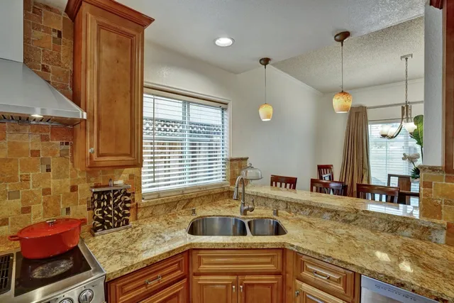 a kitchen with sink refrigerator and window