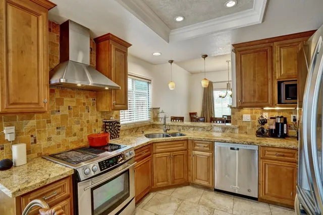 a kitchen with a stove sink and cabinets