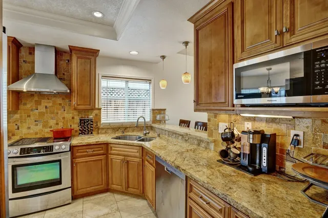 a kitchen with a sink stove and cabinets