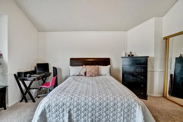 a bedroom with a bed and a tv on table