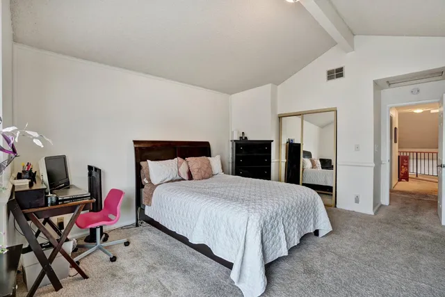 a bedroom with a bed and chair